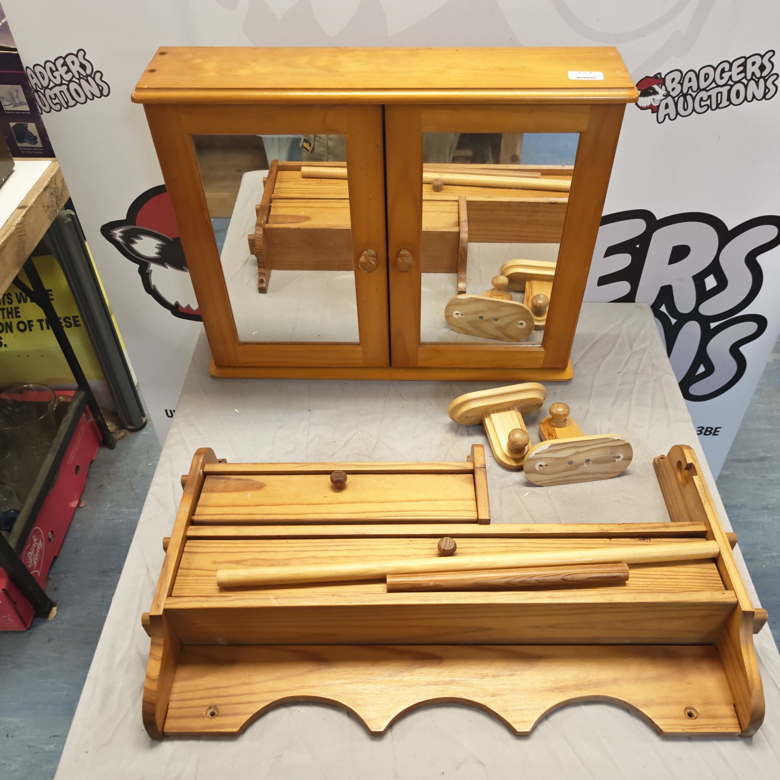 Vintage pine bathroom cabinet with wall mounted shelf for storage.
