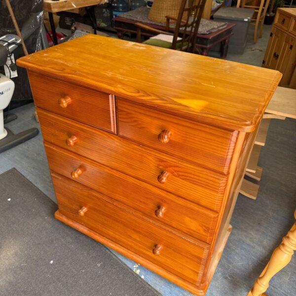 Vintage pine chest of drawers with visible surface scratches.