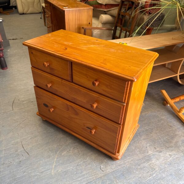 Vintage pine chest of drawers with wooden knobs.