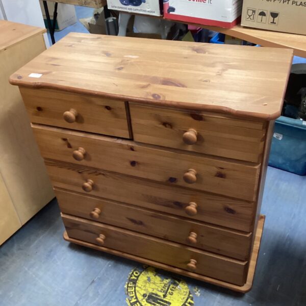 Vintage pine chest of drawers with three drawers for bedroom storage.