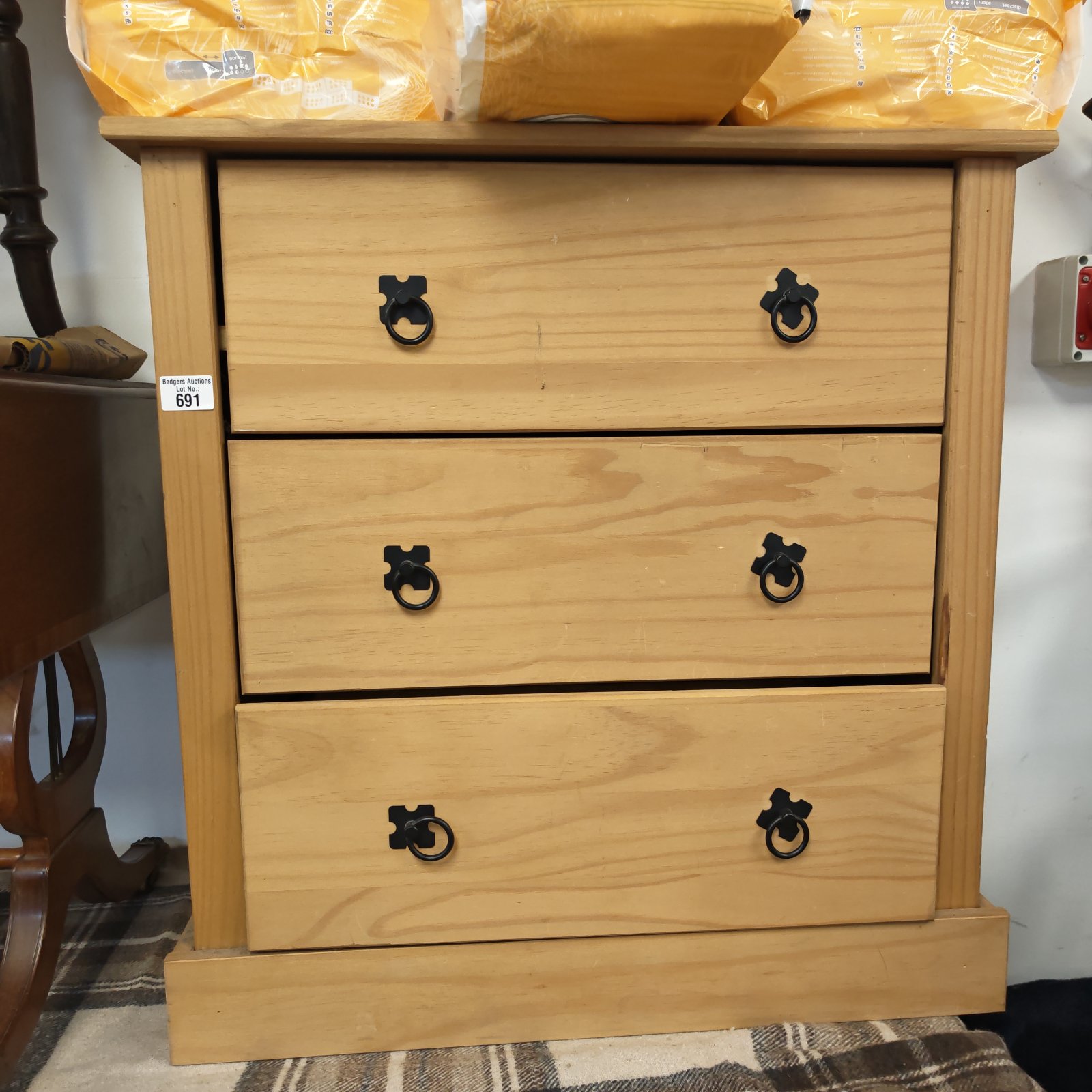Vintage pine chest of drawers with three drawers for bedroom storage.
