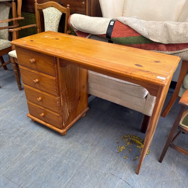 Vintage pine four drawer desk with claw marks.