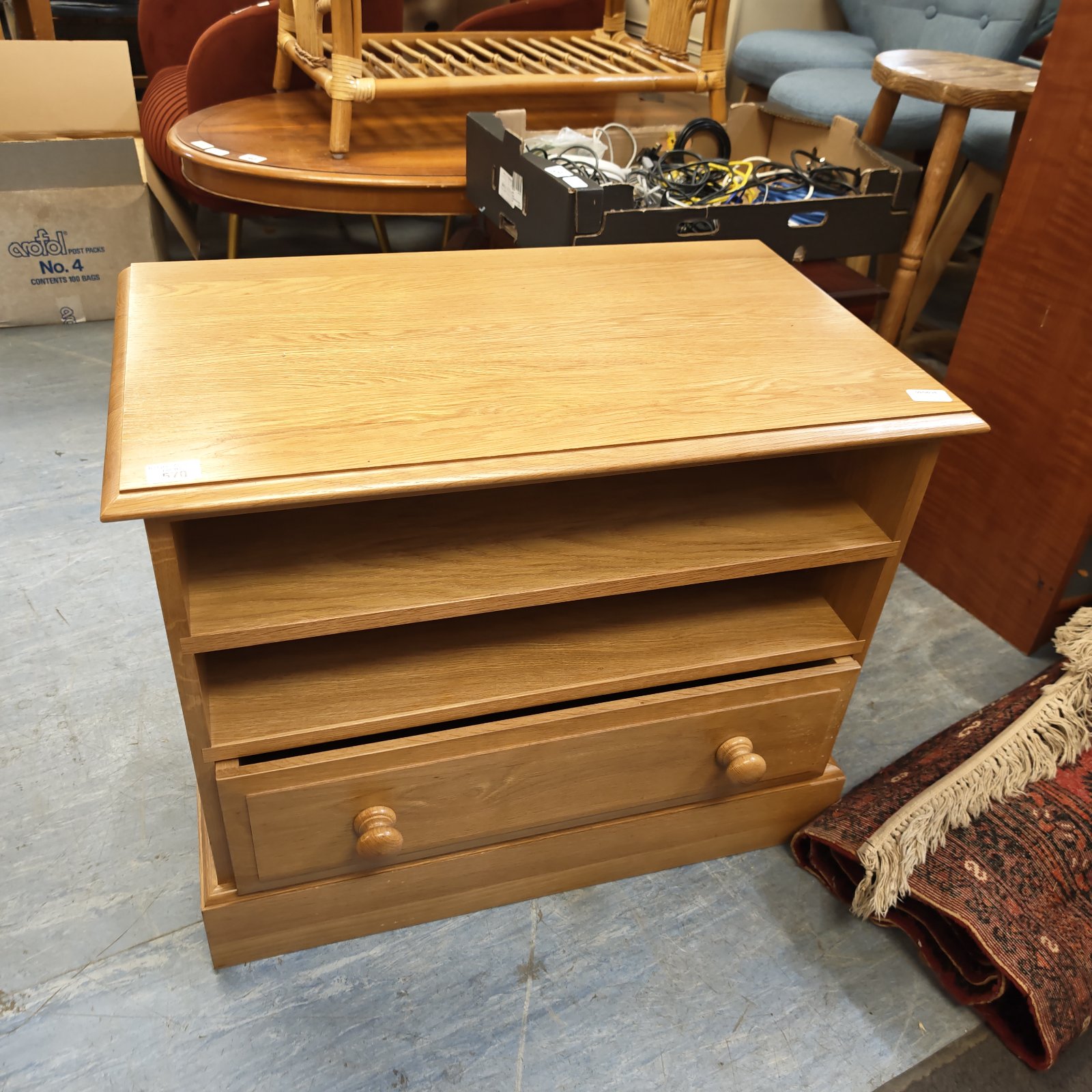 Small pine media cabinet with a single drawer and open shelf.