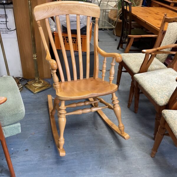 Vintage pine rocking chair with a spindle back.