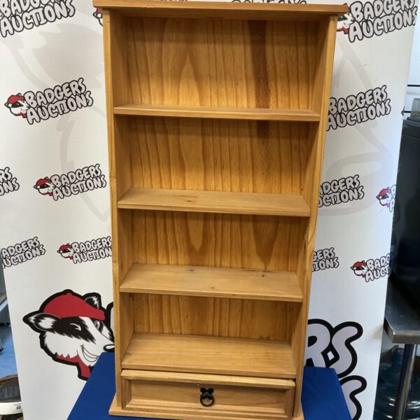 Vintage pine shelving unit with a drawer for storage.