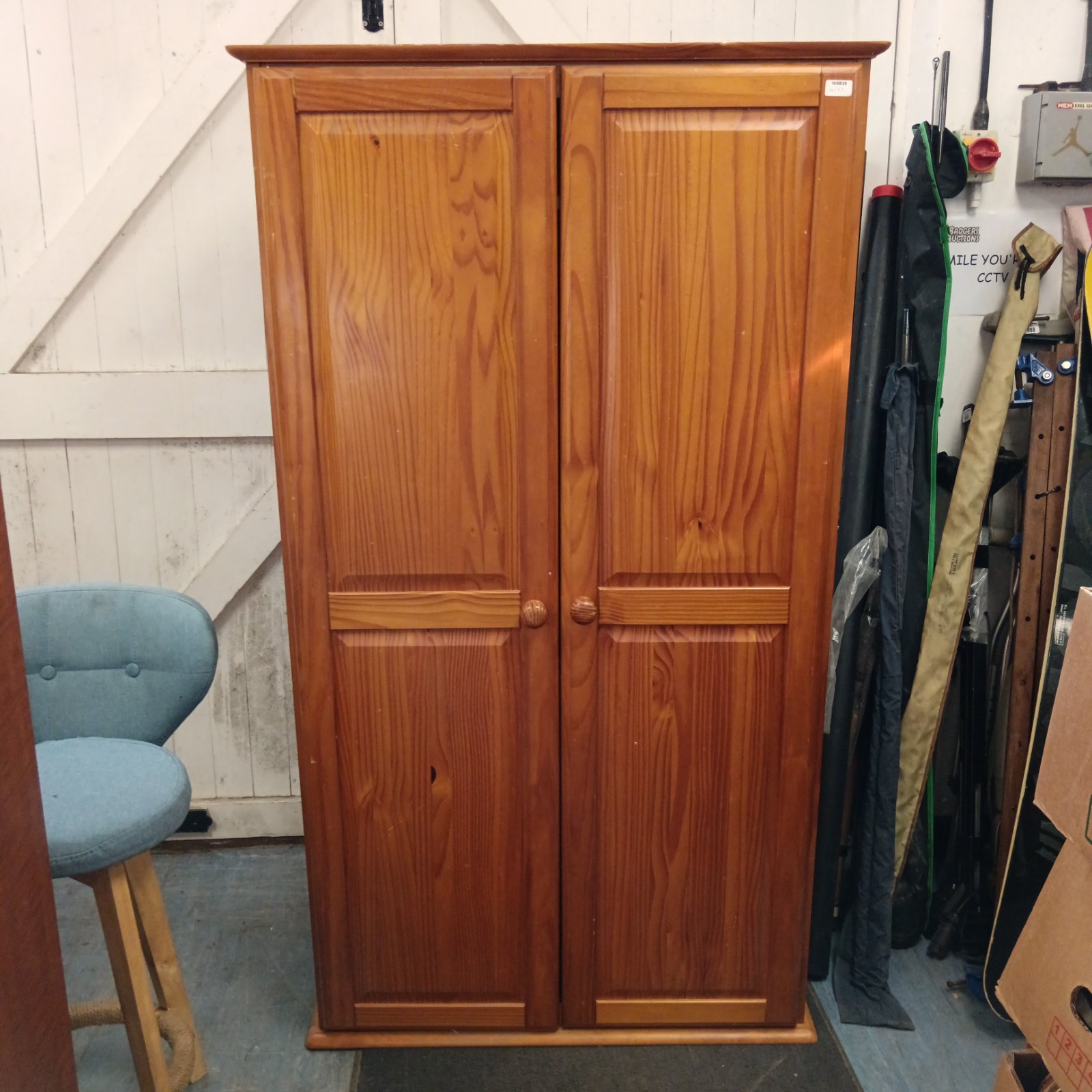 Vintage pine wardrobe with two doors, ideal for bedroom storage.