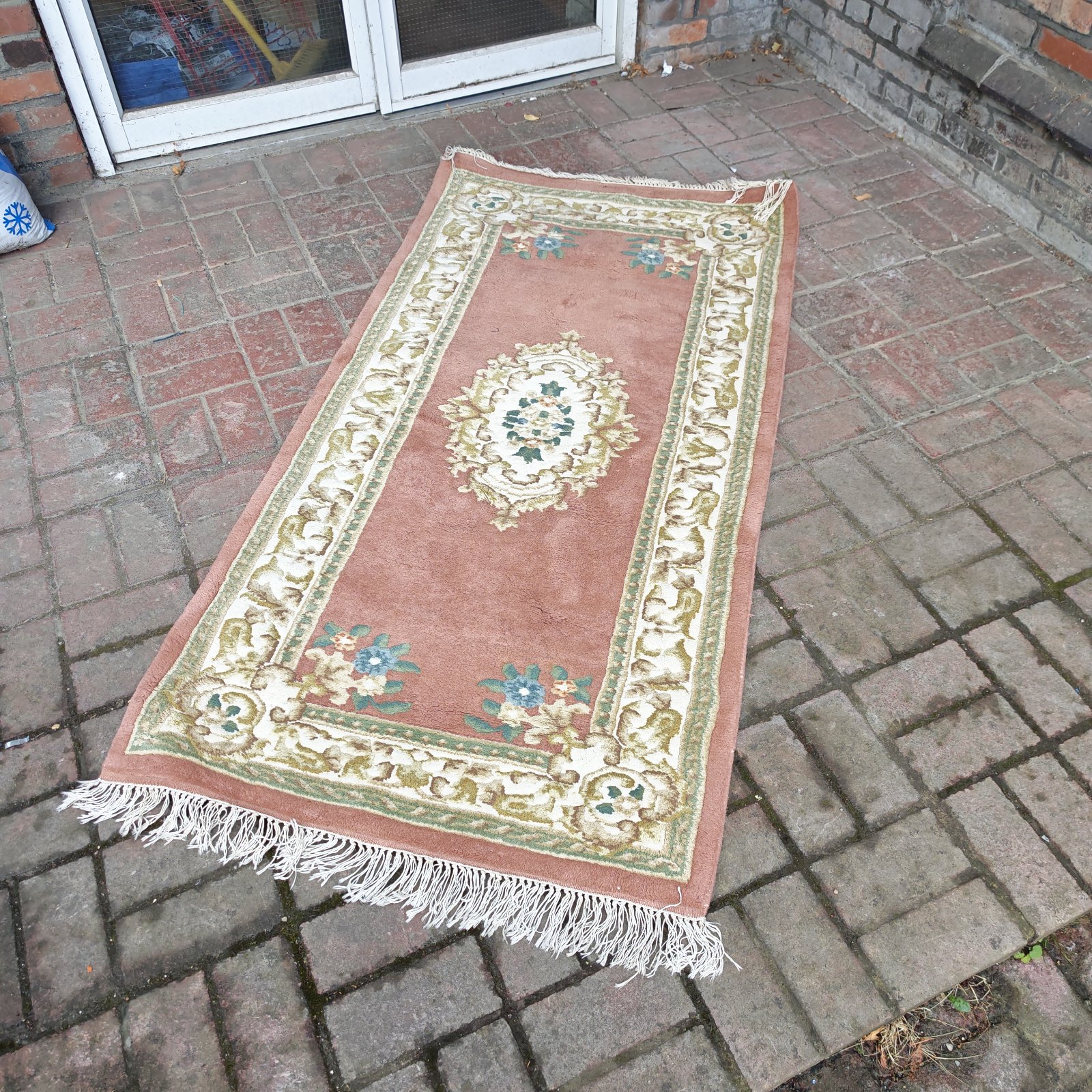 Pink floral runner rug with a detailed pattern.