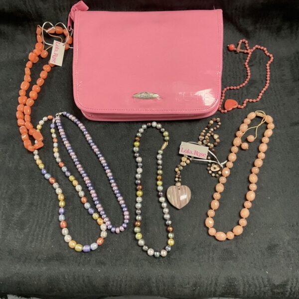 Pink jewellery lot featuring necklaces and a handbag.