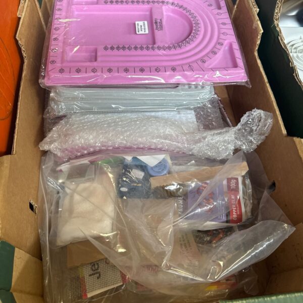 Pink plastic jewellery making tray with compartments for beads.