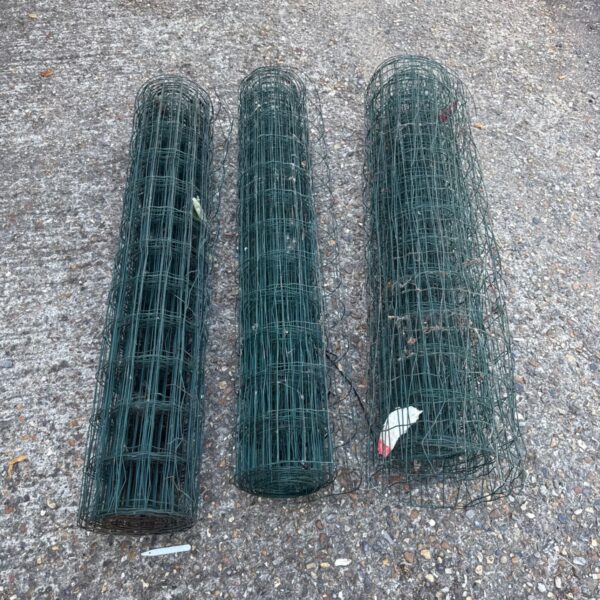 Three rolls of plastic coated wire fencing for garden use.