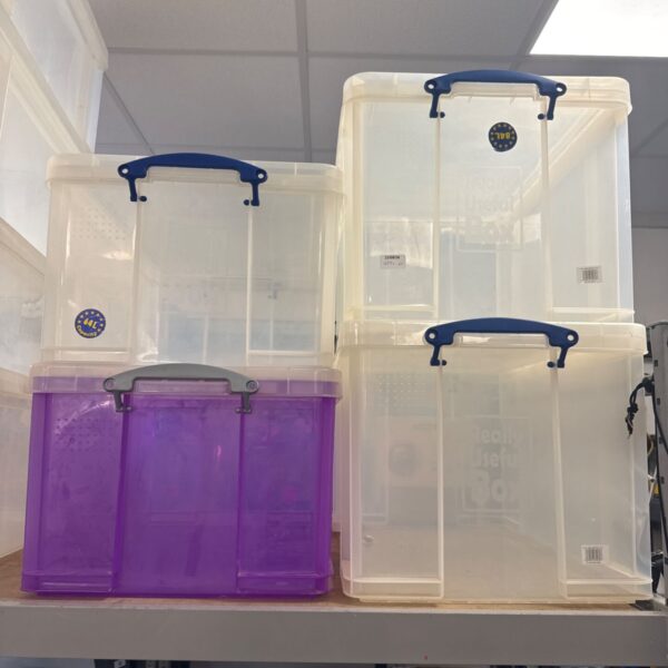 Lot of four plastic storage boxes with lids, including Really Useful brand.
