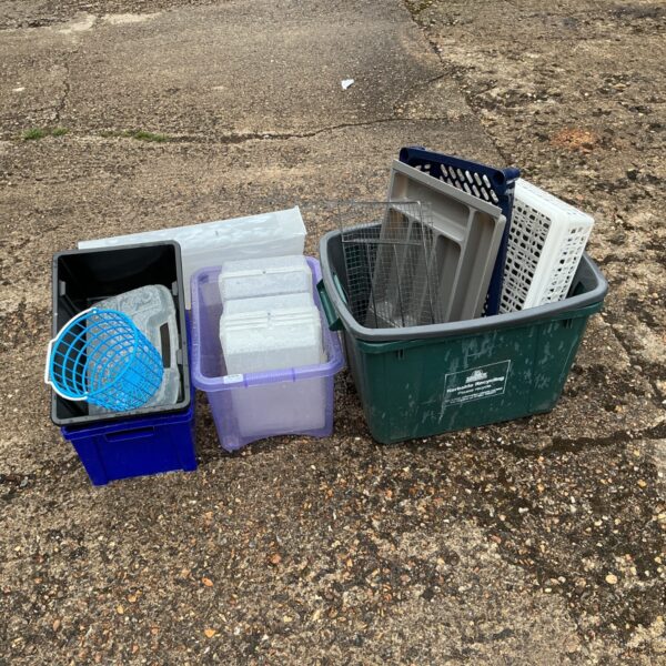 Assorted plastic storage boxes and trays in a mixed lot.