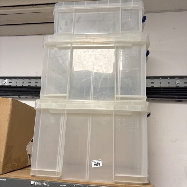 Three plastic storage boxes with lids for home organisation.