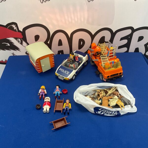Playmobil lot featuring a police car, truck, figures and Britains animals.