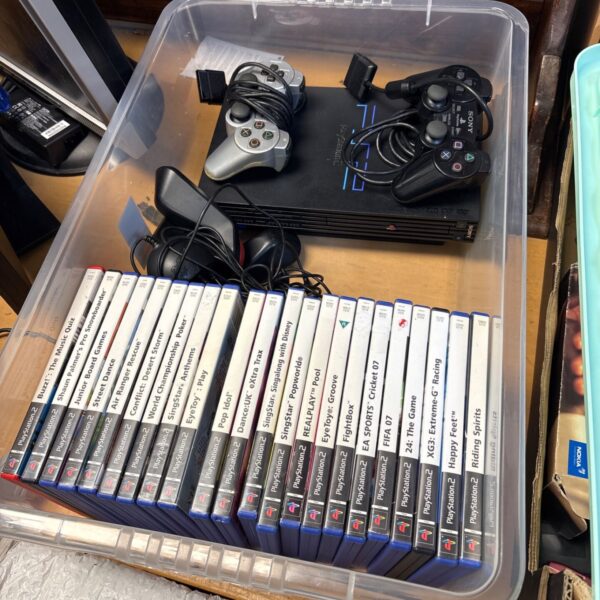 PlayStation 2 console bundle with games and controllers.