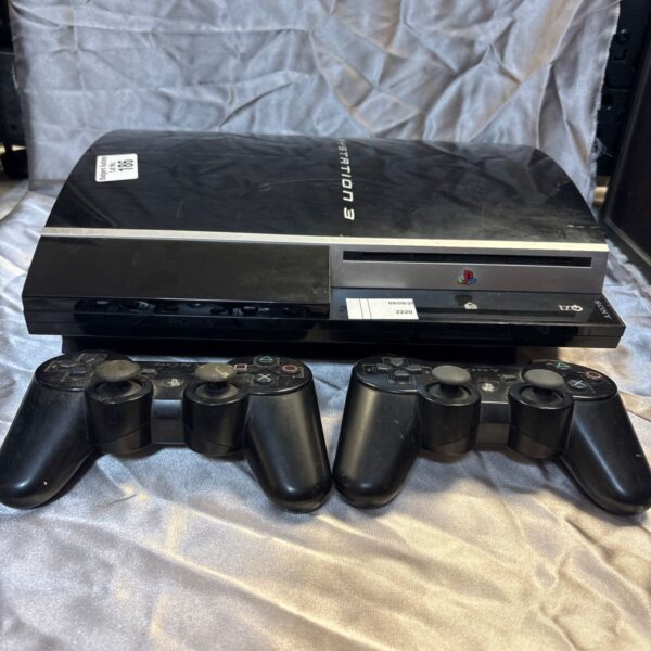 Black Sony PlayStation 2 console with two controllers.