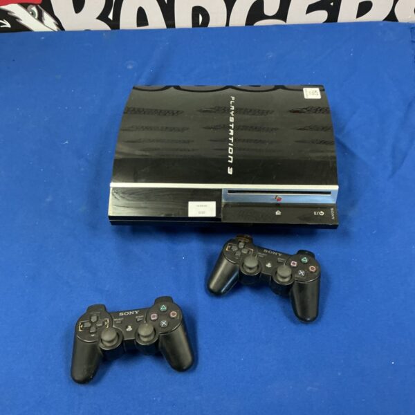 Black PlayStation 3 console with two controllers for retro gaming.
