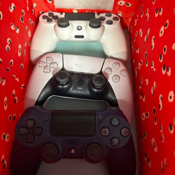 Two Sony PlayStation controllers, a DualShock 4 and DualShock 5.