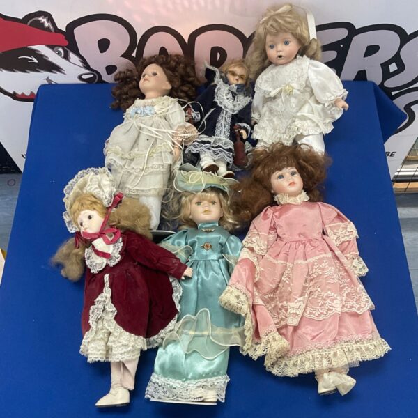 Lot of six vintage porcelain dolls in a group.