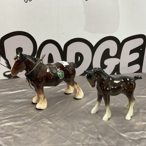 Vintage porcelain horse ornaments, including Melba ware, on display.