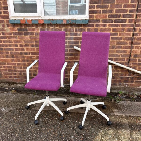 Pair of purple office task chairs with wheels.