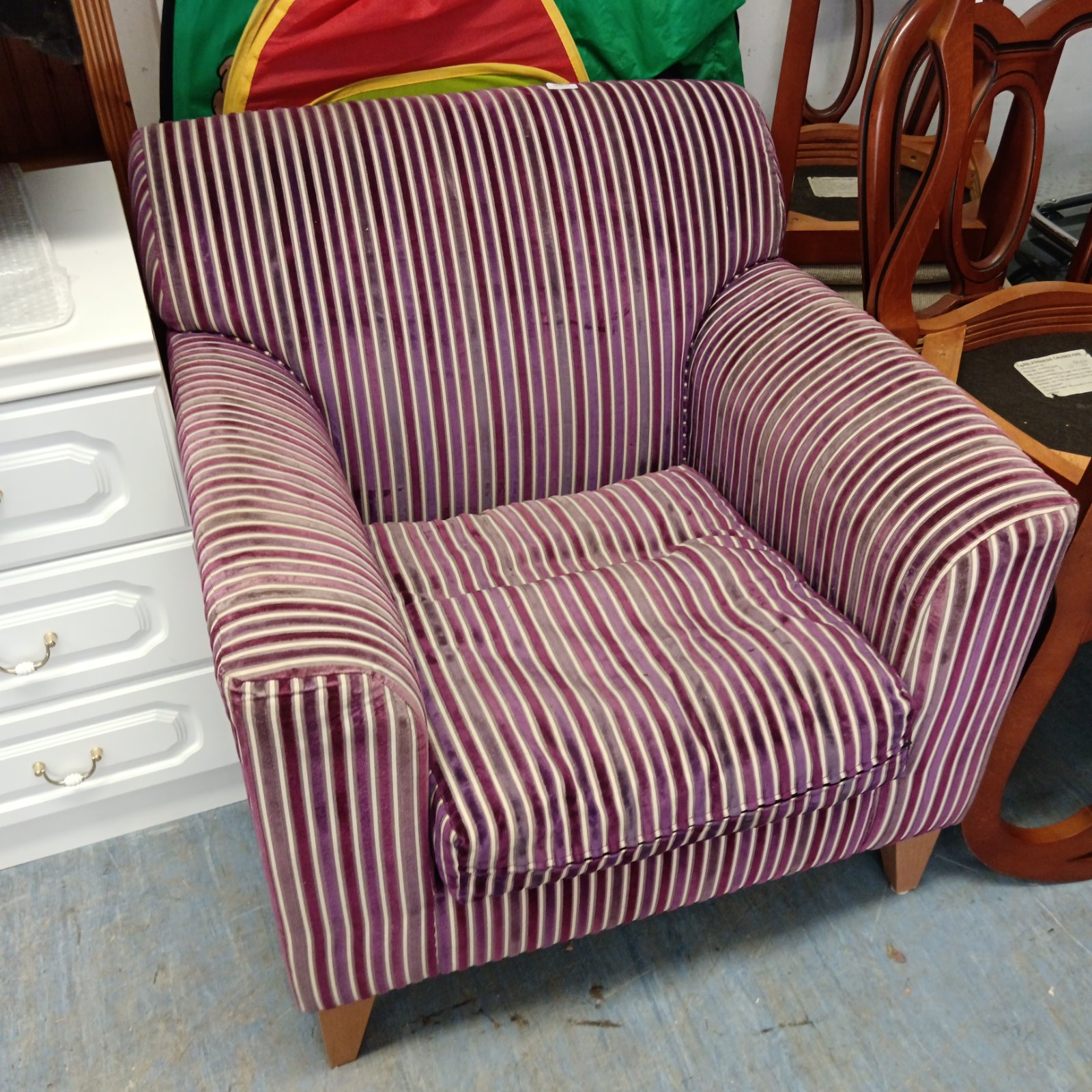 Vintage purple striped armchair with wooden legs.