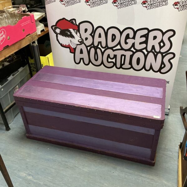Large purple painted wooden chest for storage and display.