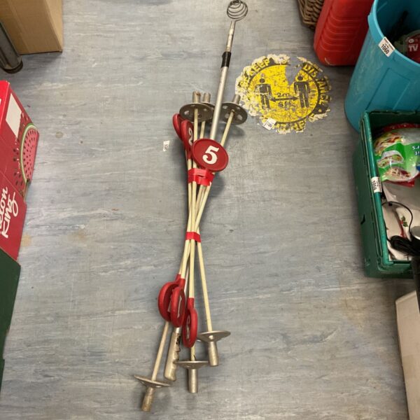 Set of five vintage putting green hole markers for golf.