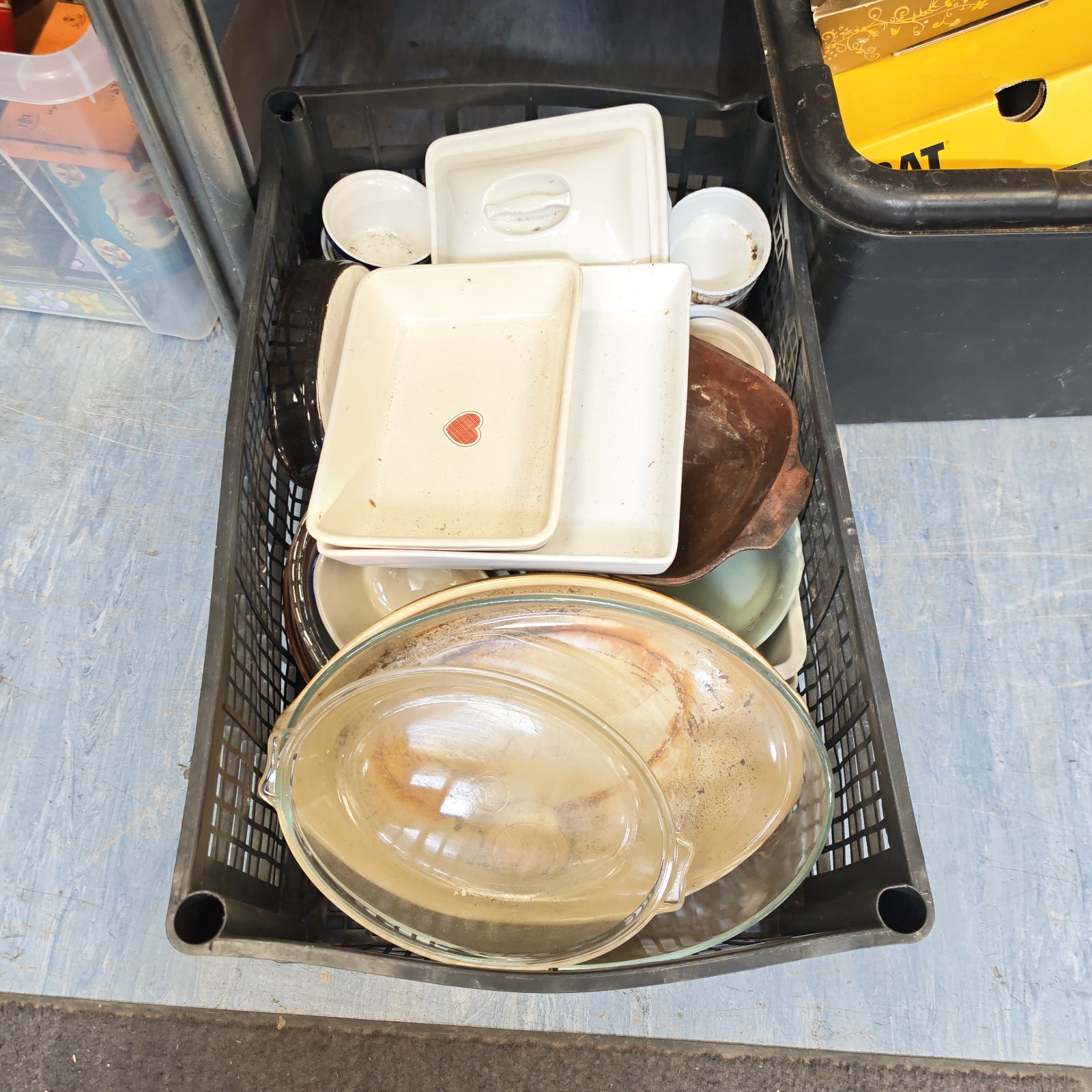 Crate of mixed vintage Pyrex style dishes and ramekins.