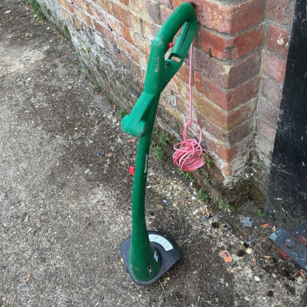 Used Qualcast electric strimmer for garden maintenance and lawn edging.