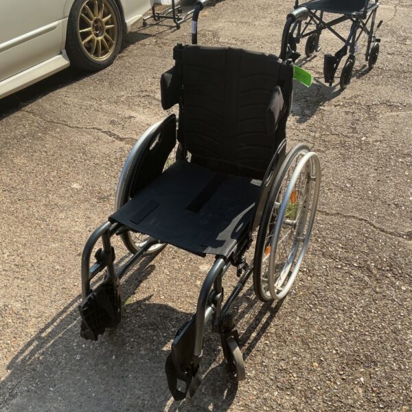 Used Quickie wheelchair with a rigid frame, ideal for active users.