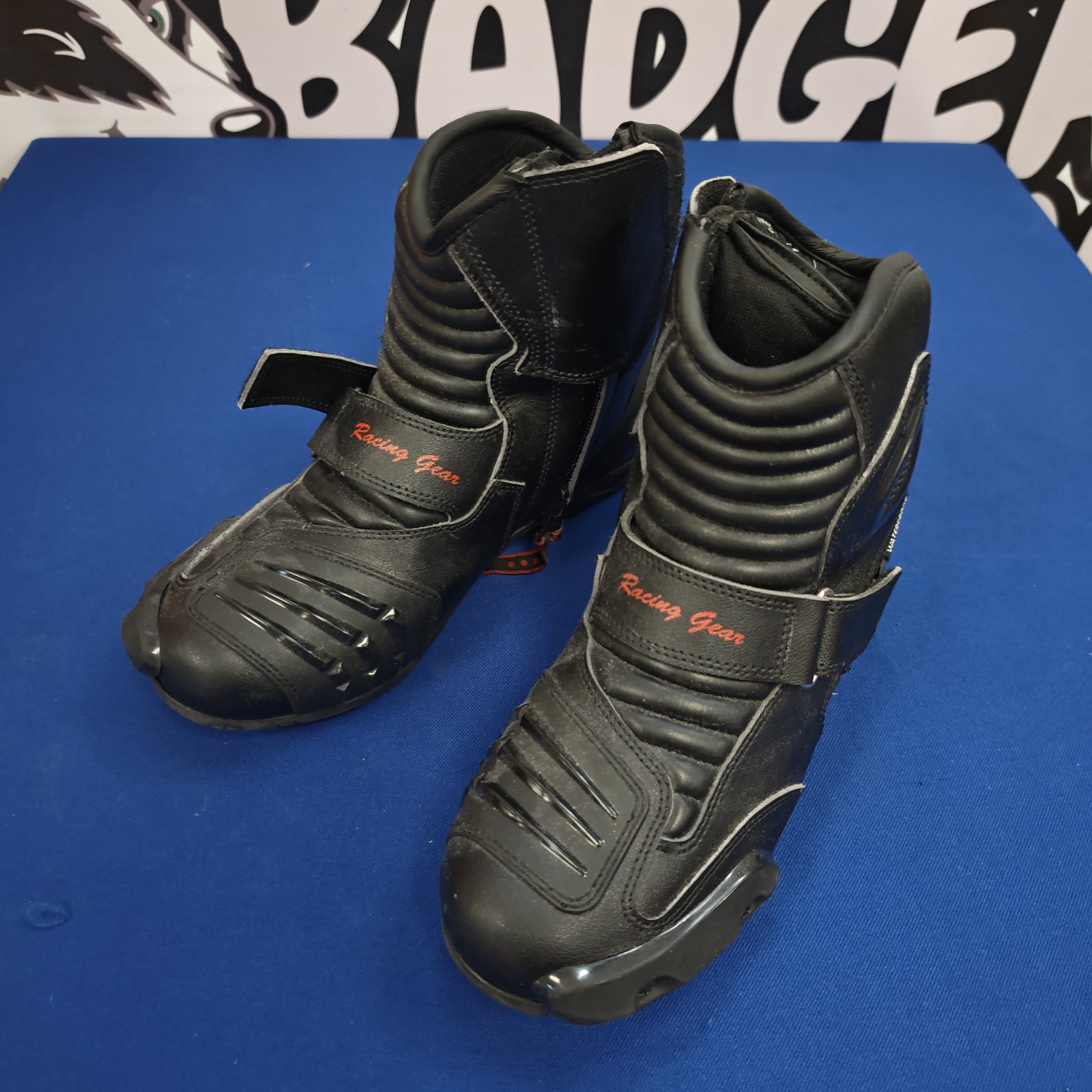 Black size 8 racing motorcycle shoes with strap closure.