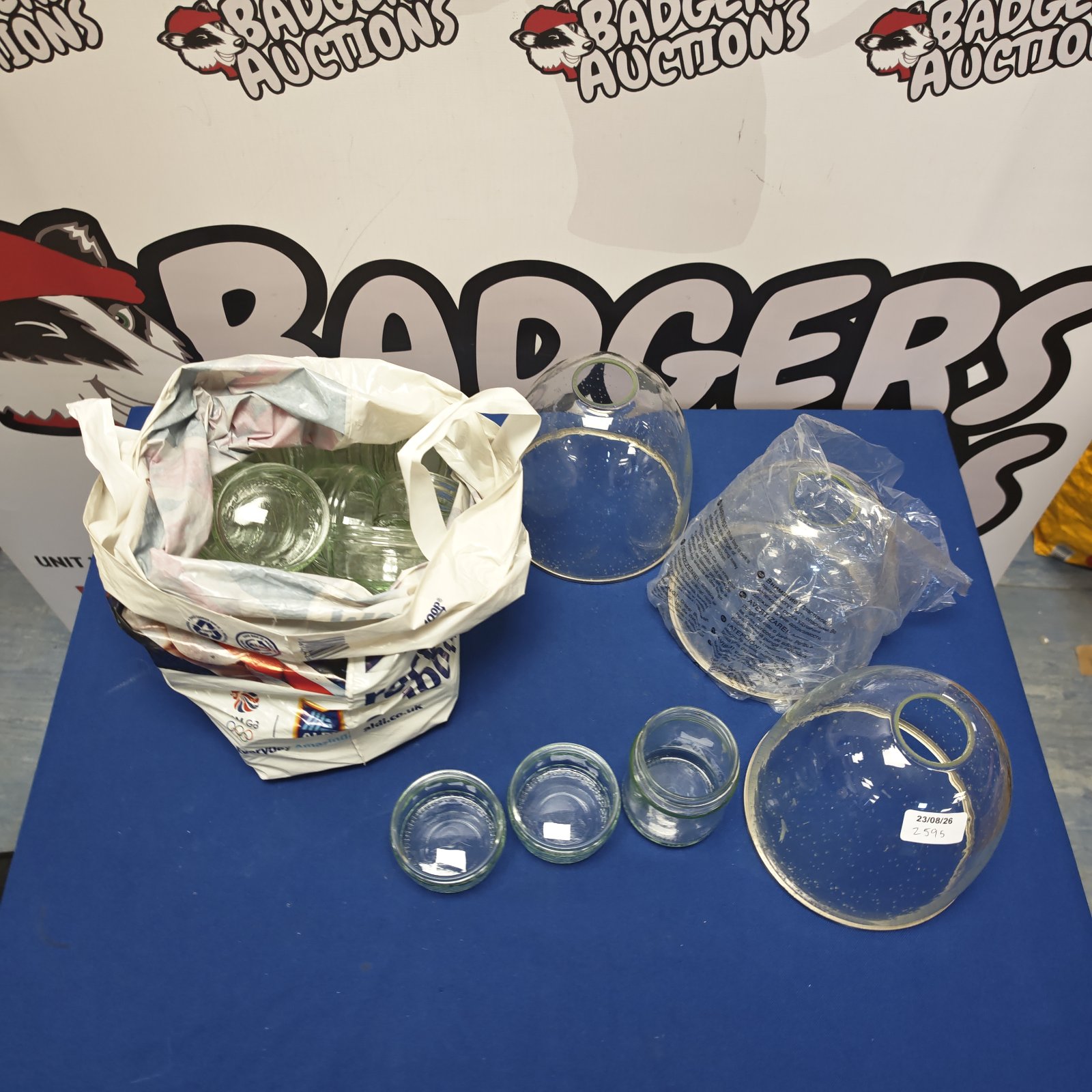 Mixed lot of glass ramekins and lamp shades for sale.