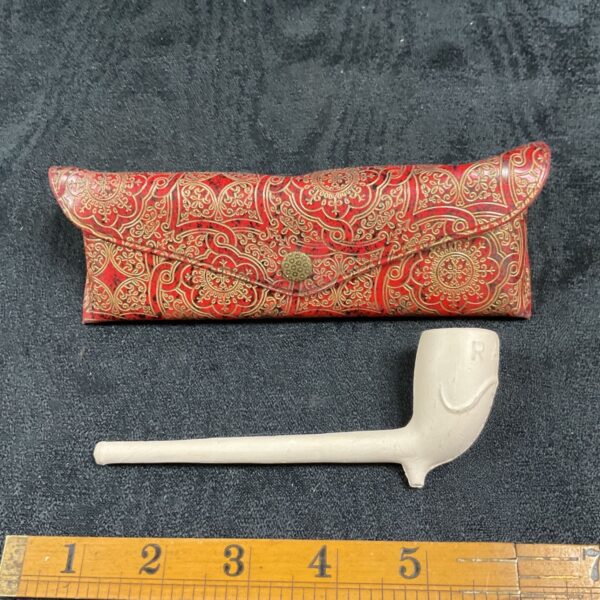 Vintage RAOB clay pipe with embossed red case, collectible fraternal item.
