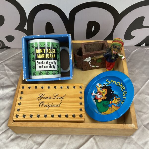 Rasta collectibles set featuring a mug, pen holder, ashtray, and rolling box.