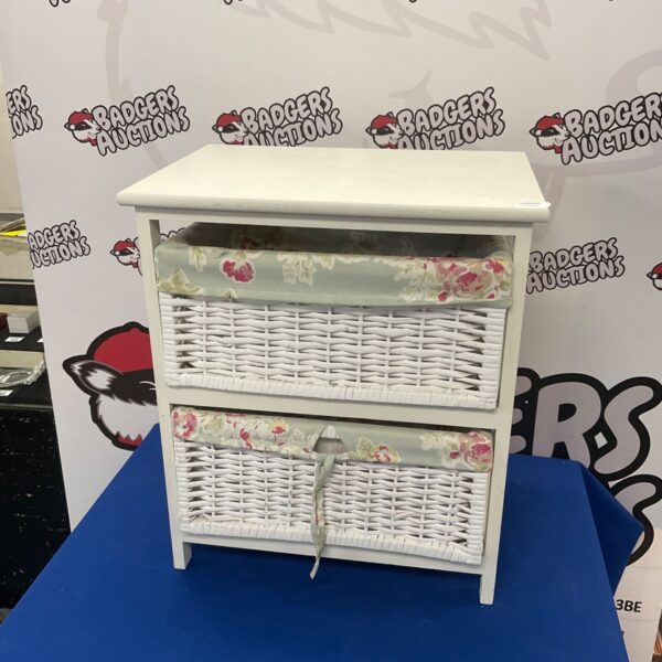 White rattan storage unit with floral drawers, ideal for home decor.