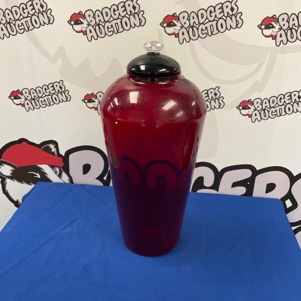 Vintage red glass vase with stopper, ideal for home decoration.