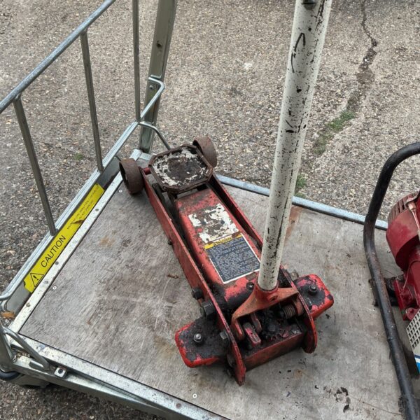 Red hydraulic floor jack, a heavy duty trolley jack for car maintenance.