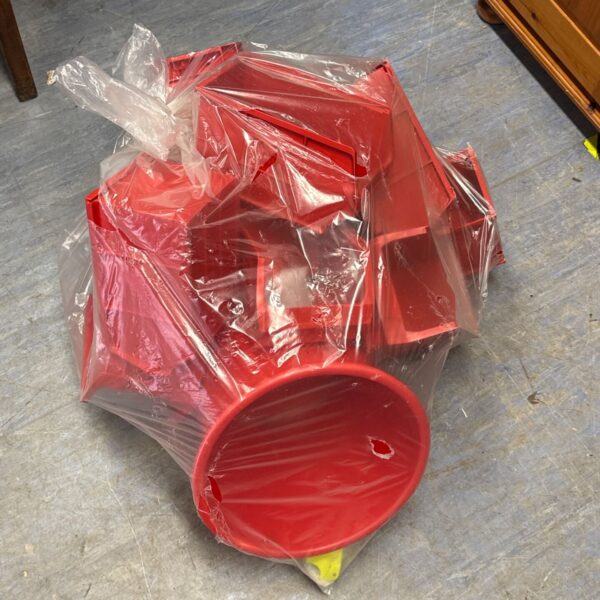 Lot of red plastic storage organisers for home or garage.