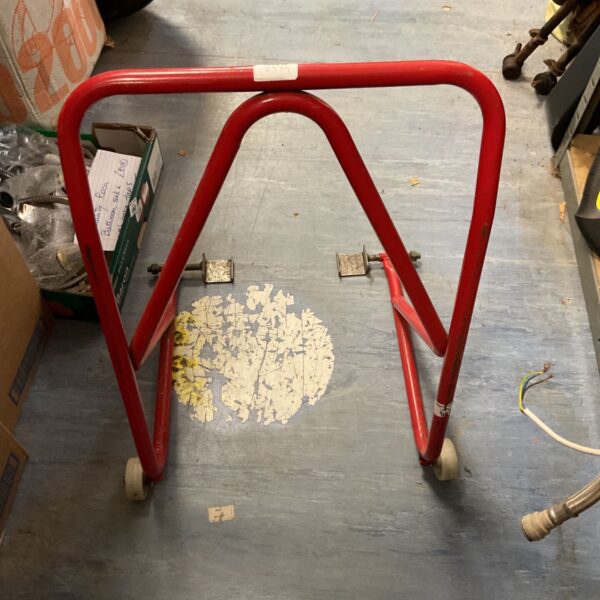 Red tubular roll cage for vehicle safety and vintage racing.