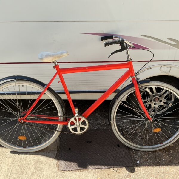 Bright red vintage city bicycle with white-wall tires.