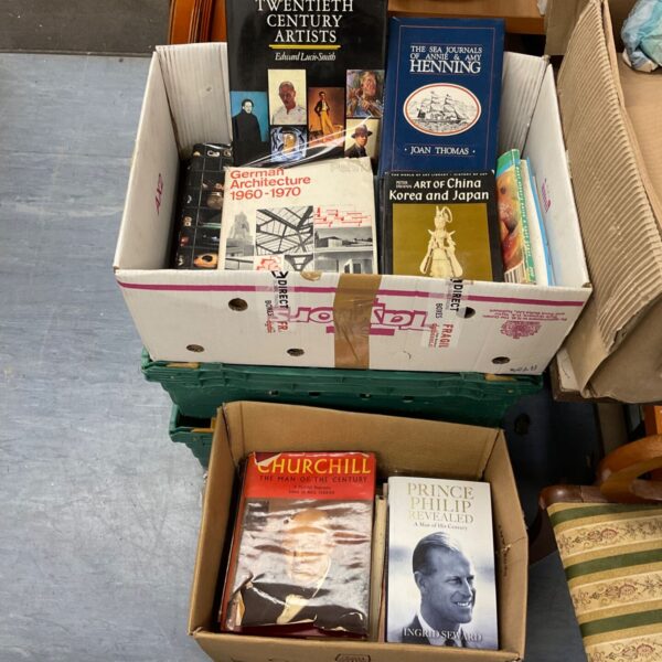 Stack of boxes filled with reference books and autobiographies.