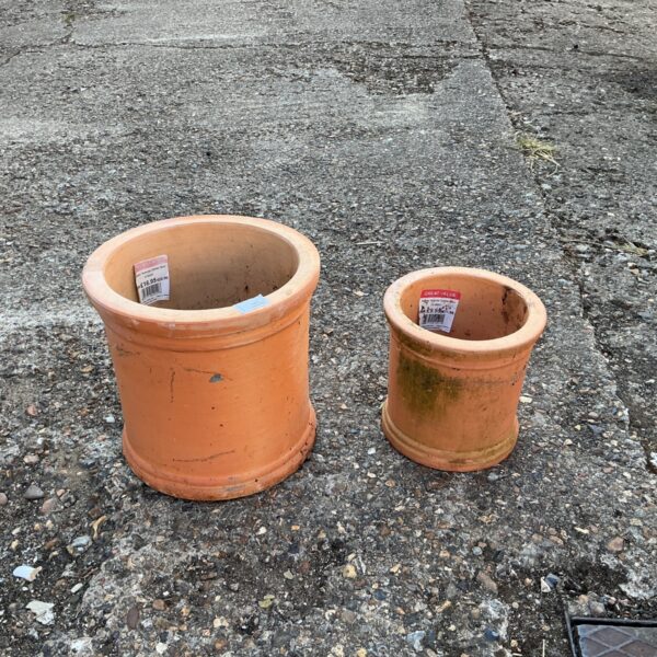 Regency terracotta cylinders for garden decoration, showing signs of age.