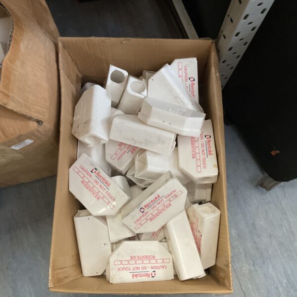 Used Rentokil rodenticide bait stations in a cardboard box.