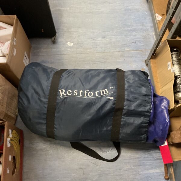 Blue Restform inflatable mattress rolled up for storage.