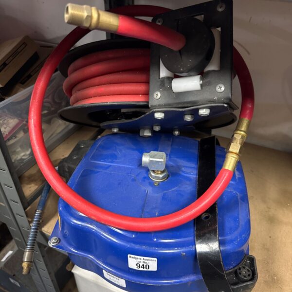 Blue and red retractable air hose reels for workshop use.