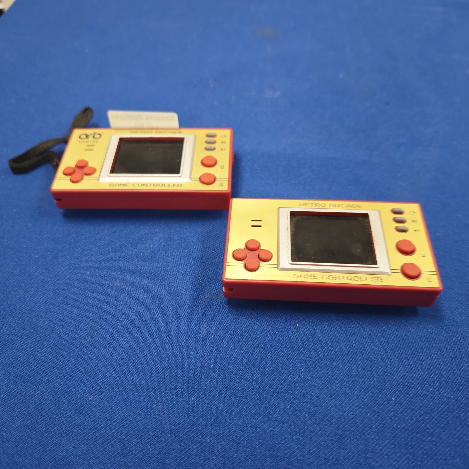Two retro handheld game consoles, vintage portable gaming devices.