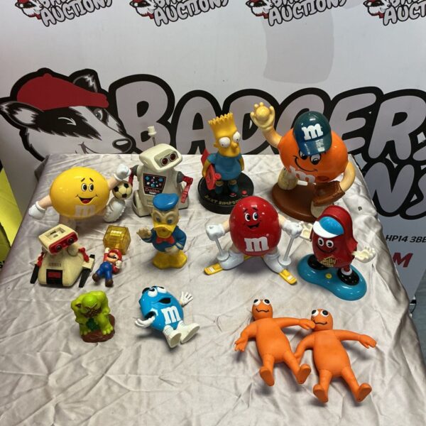 Retro toy lot featuring M&M figures, Tomy CrackBot, and Bart Simpson alarm.