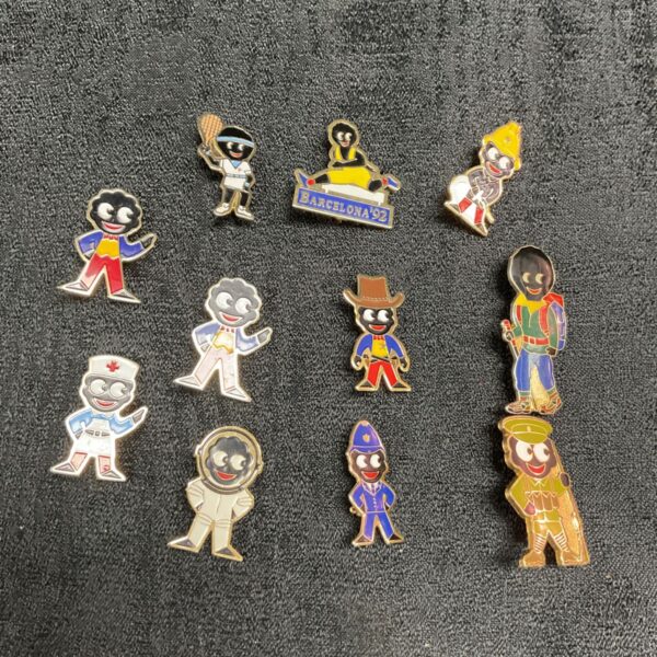 Group of eleven vintage Robertson golly enamel badges.