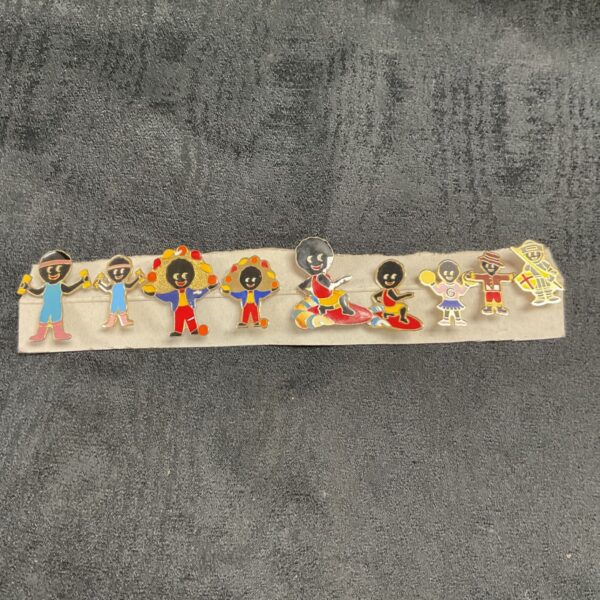 Group of nine vintage Robertson Golly enamel badges.